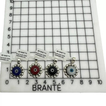 CADENA CON DIJE OJO MARGEN BOLEADO